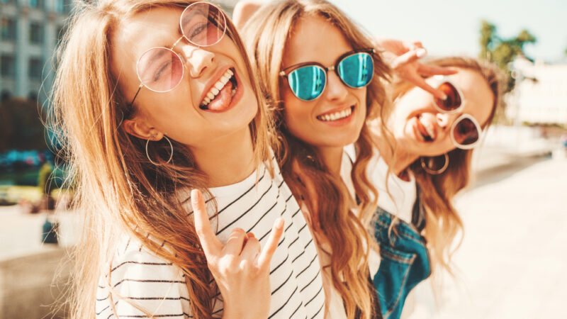Three smiling girls in summer