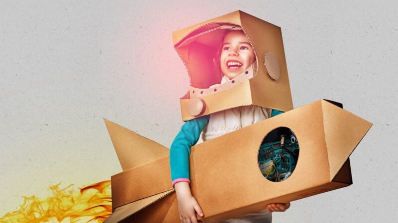 Child with cardboard rocket