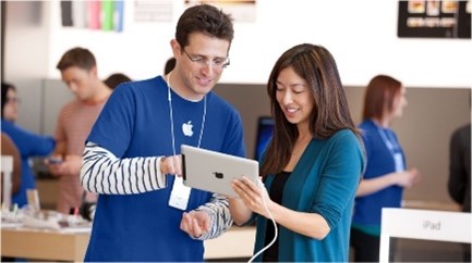 Apple employee helping customer